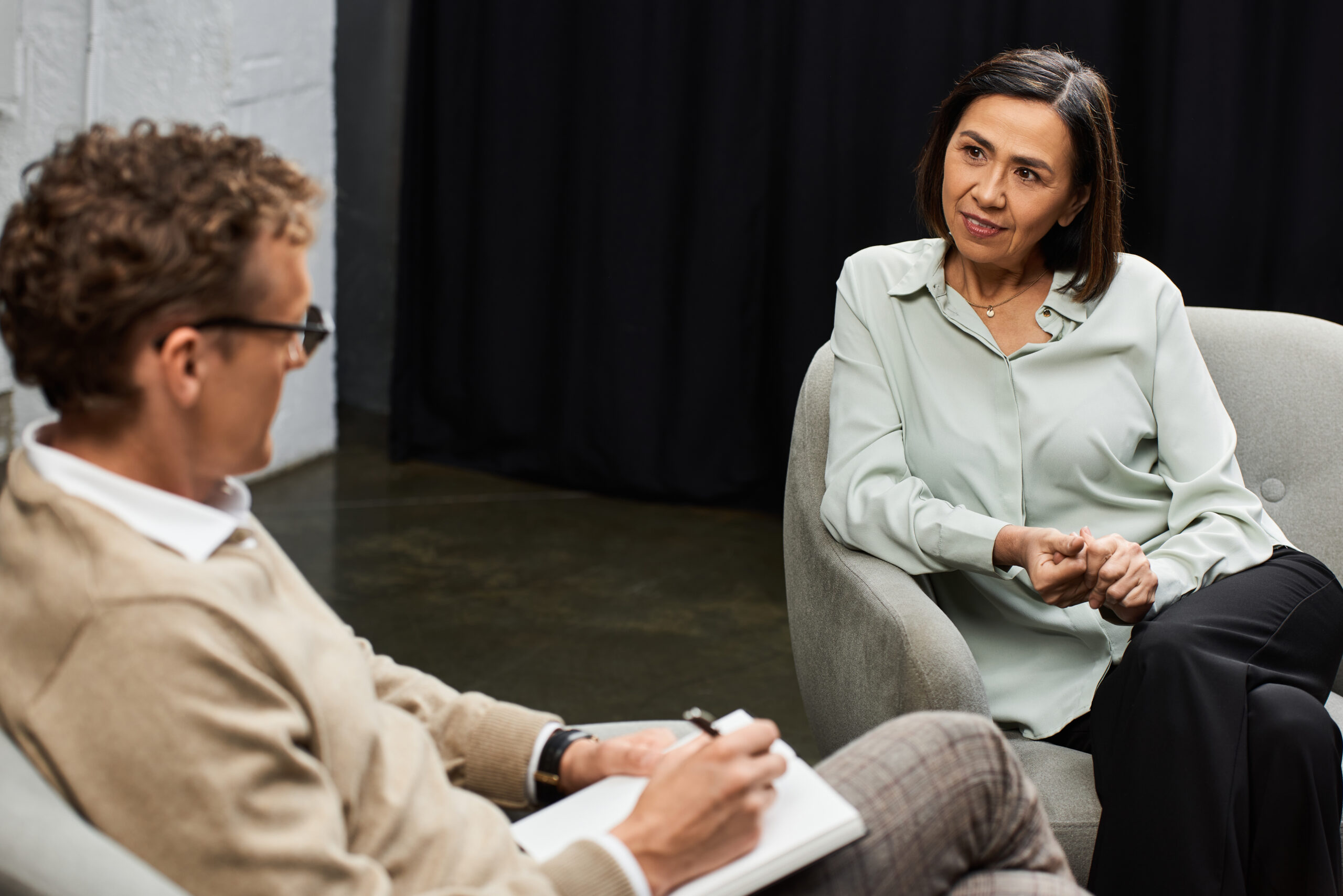A journalist in a cozy studio engages with a specialist, uncovering her insights and professional expertise.